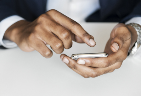 A man using his iPhone.