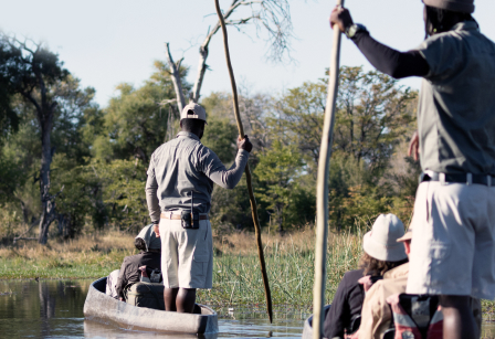 Tour guides crossing a river in a boat.