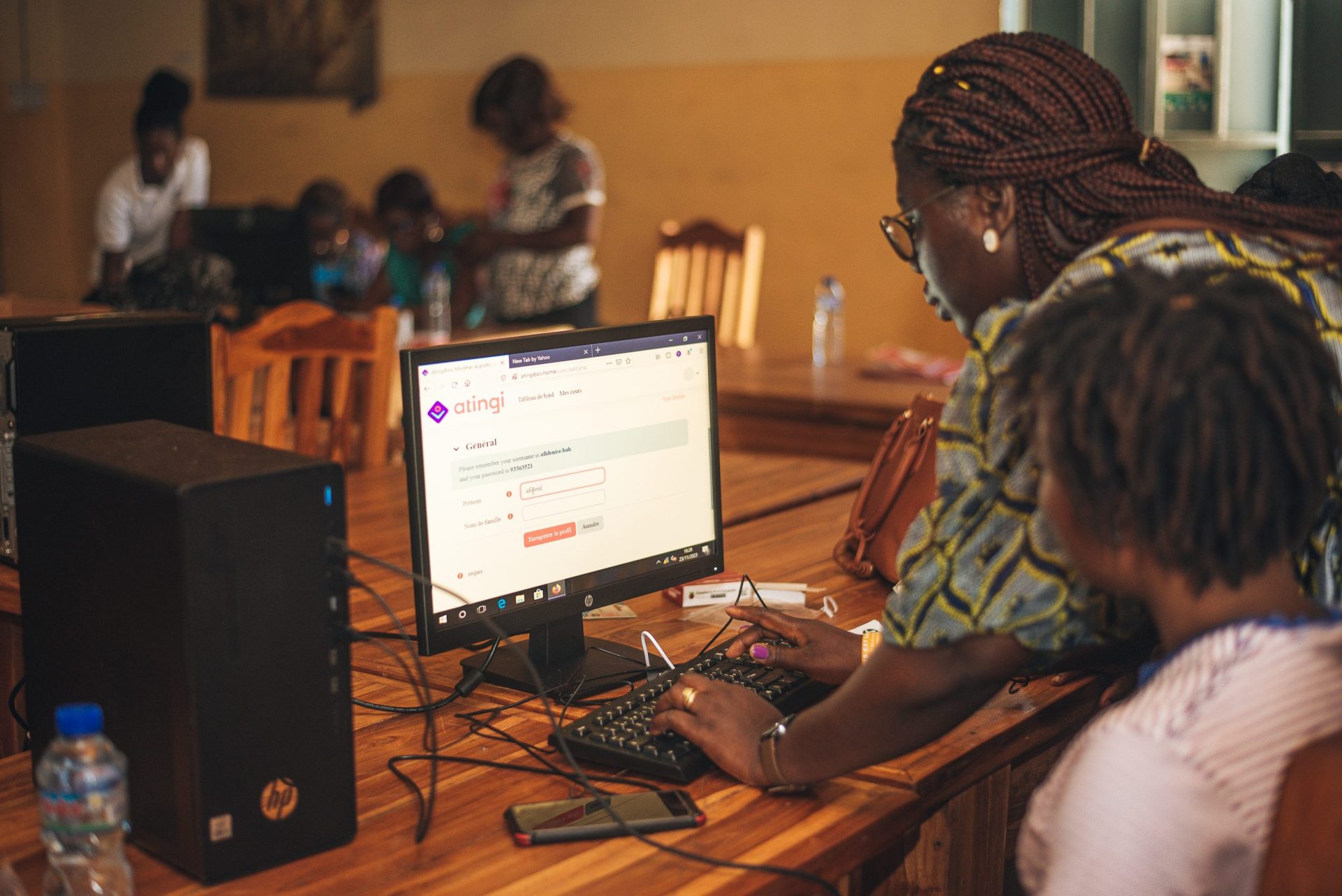 Woman registering on atingi on a desktop computer